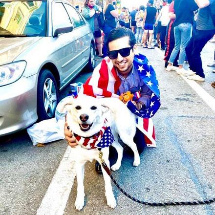 Me with a friend’s dog at a political rally, celebrating results of the 2020 presidential election (fall 2020)